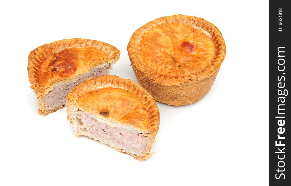 Delicious home baked pork pies on a white background