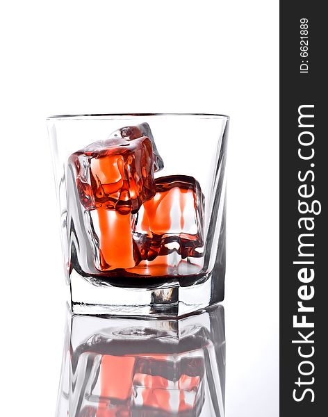 A drinking glass with bloody ice cubes