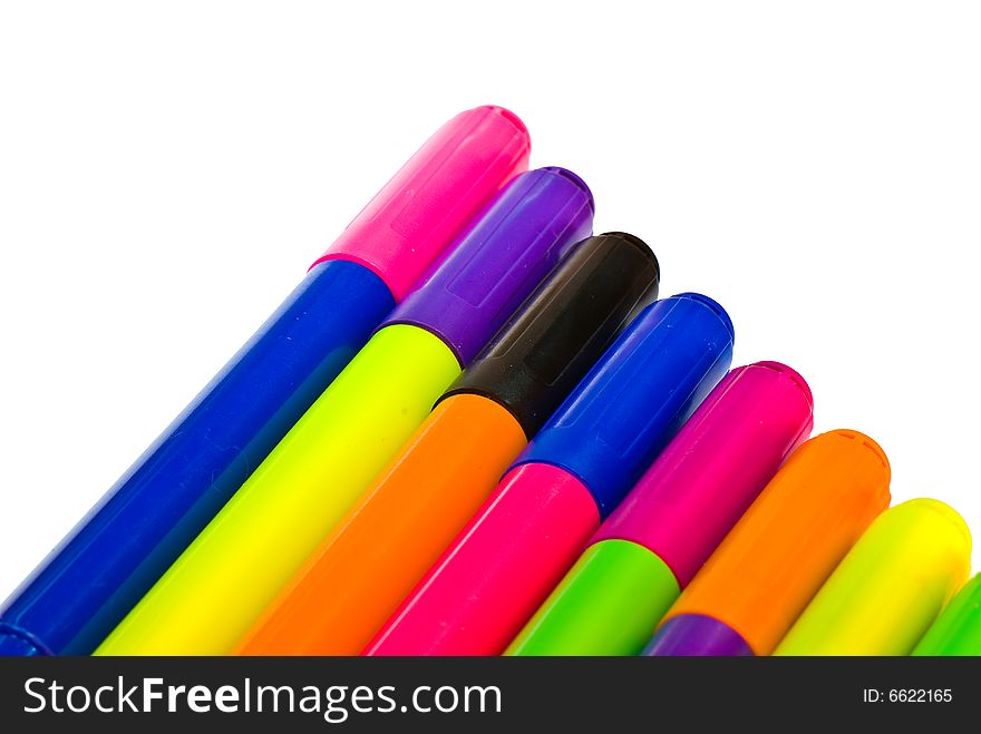 Varicoloured markers on the white isolated background