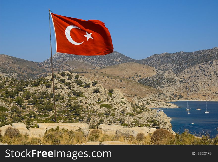 Turkish flag over ancient fortress Loryma (Buzukale Bozuk Buku), Turkey. Turkish flag over ancient fortress Loryma (Buzukale Bozuk Buku), Turkey