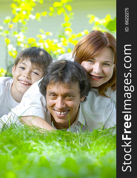 Portrait of young happy family in summer environment. Portrait of young happy family in summer environment