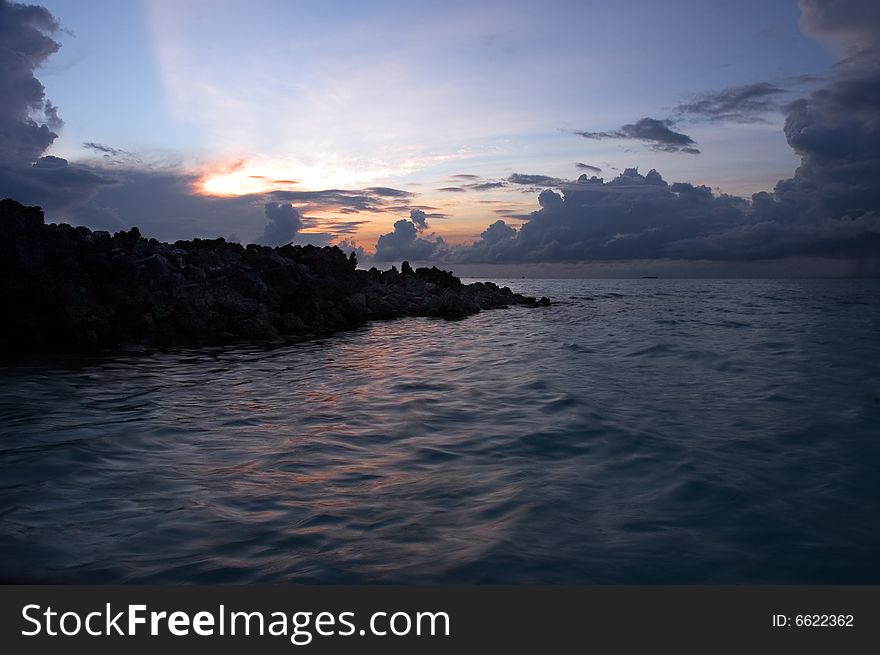 Water, clouds and rocks at sunrise. Water, clouds and rocks at sunrise