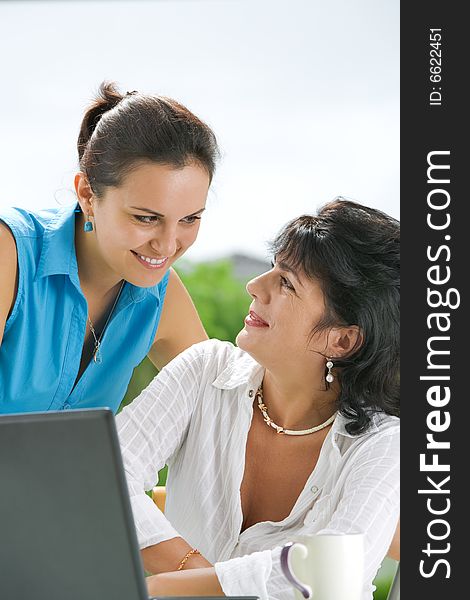 Portrait of  two women  getting busy with  laptop. Portrait of  two women  getting busy with  laptop