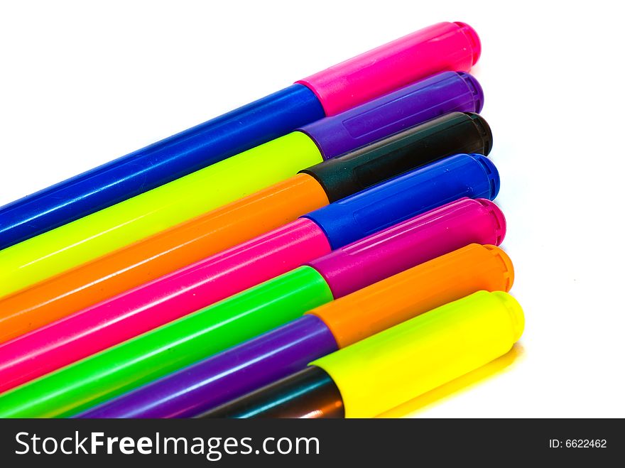 Varicoloured markers on the white isolated background