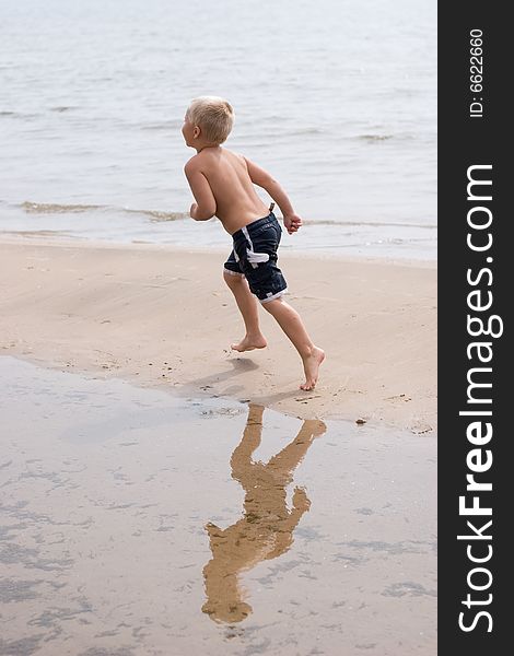 Boy Running On The Beach