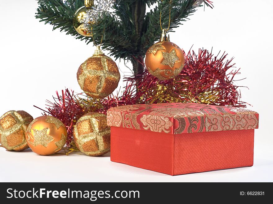 Present box under the Christmas tree isolated on a white background. Present box under the Christmas tree isolated on a white background.