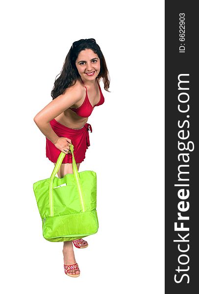 Beautiful girl, wearing red bikini and sunglasses on her head, carrying a beach bag, leaning forward. Beautiful girl, wearing red bikini and sunglasses on her head, carrying a beach bag, leaning forward