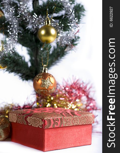 Present box under the Christmas tree isolated on a white background. Present box under the Christmas tree isolated on a white background.