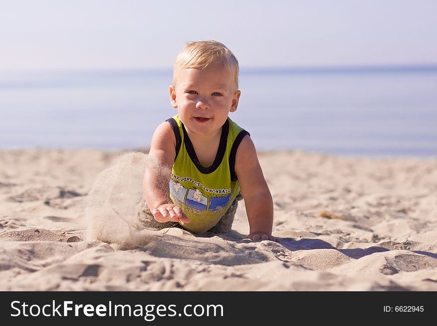 Infant playing at the beach