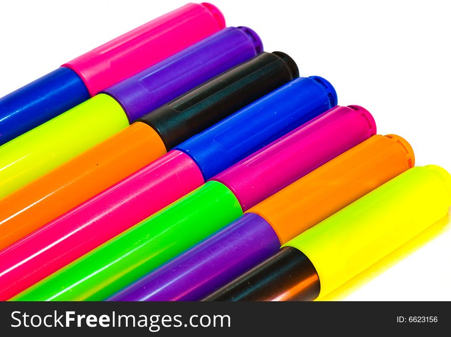 Varicoloured markers on the white isolated background