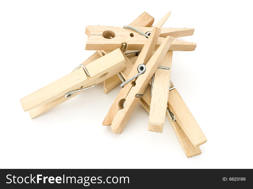 A heap of wooden clothespins on white background