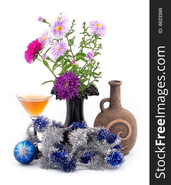 Black vase with colors and New Year's ornaments with blue spheres on white background