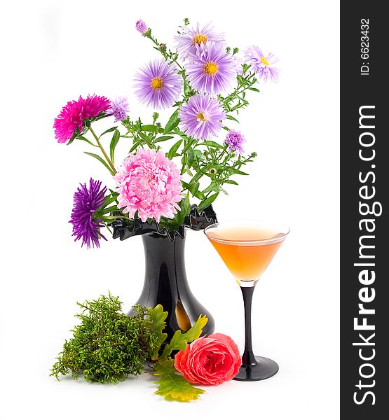 Black vase with colors and green moss with scarlet rose at wine-glass with wine on white background