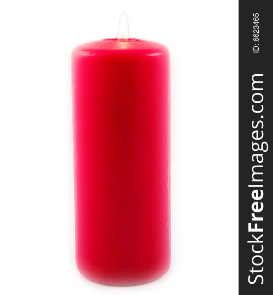Red celebratory burning candle made of paraffin on white background