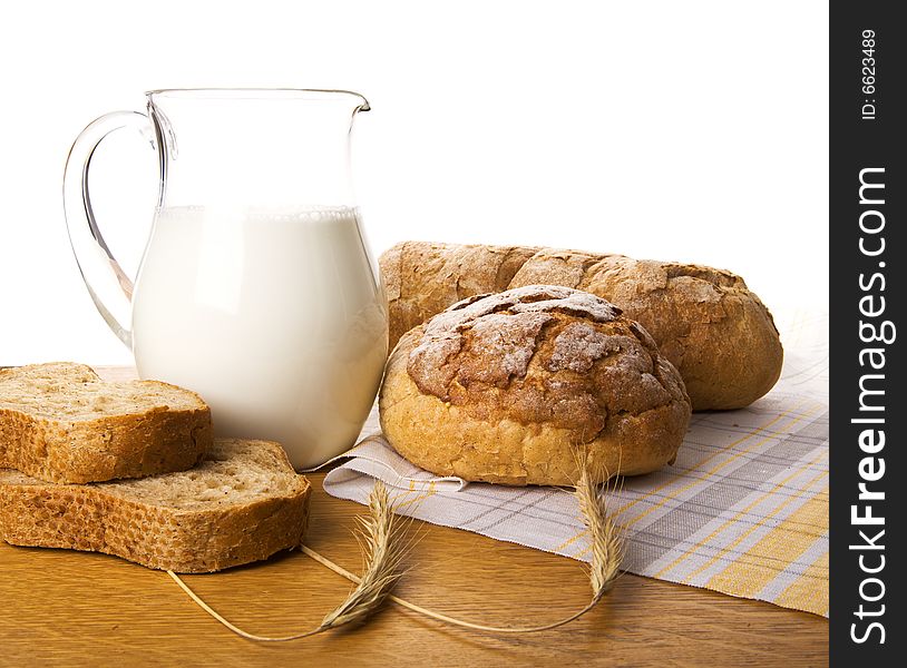 Jug with milk, bread and wheat. Jug with milk, bread and wheat