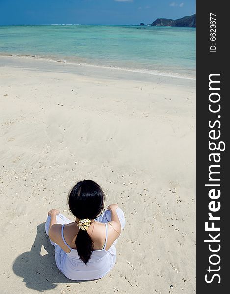 Photo of a healthy young woman meditating by the beach. Photo of a healthy young woman meditating by the beach