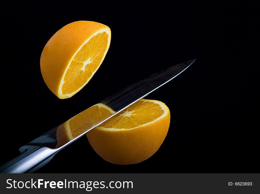 Fresh orange cut into two pieces