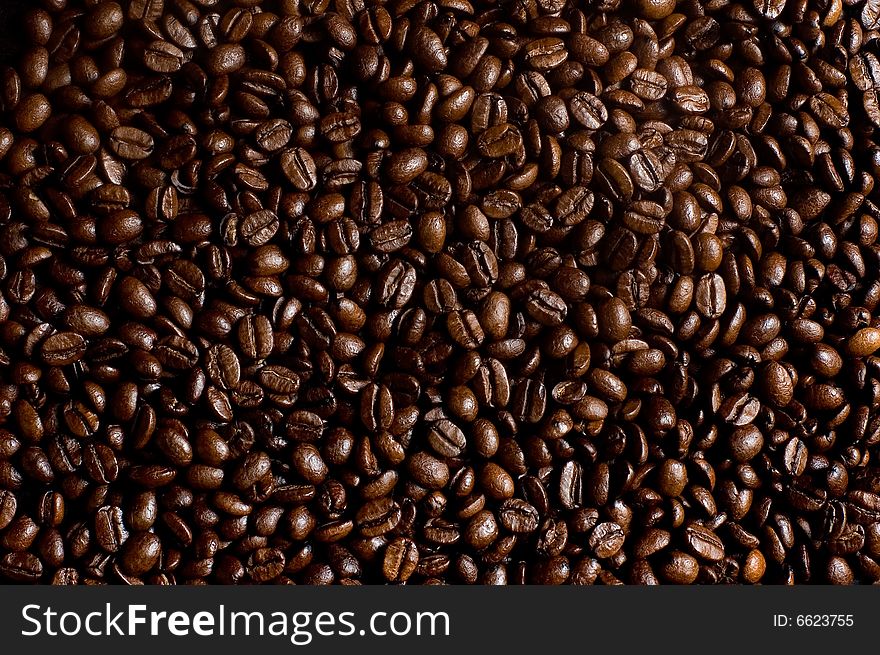 Roasted coffee beans heap macro shot. Roasted coffee beans heap macro shot