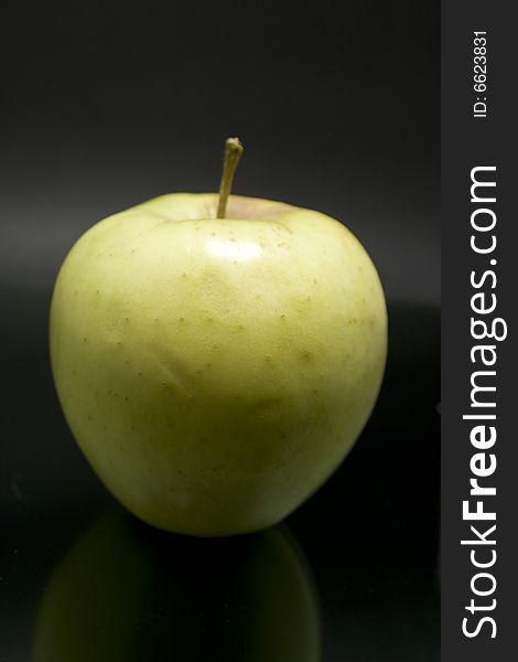 Yellow apple isolated on dark background