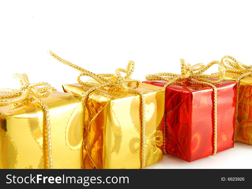Line of gold gift and one red on white background. Line of gold gift and one red on white background