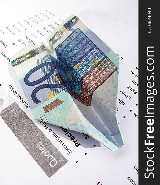 20-Euro paper airplane on a financial report