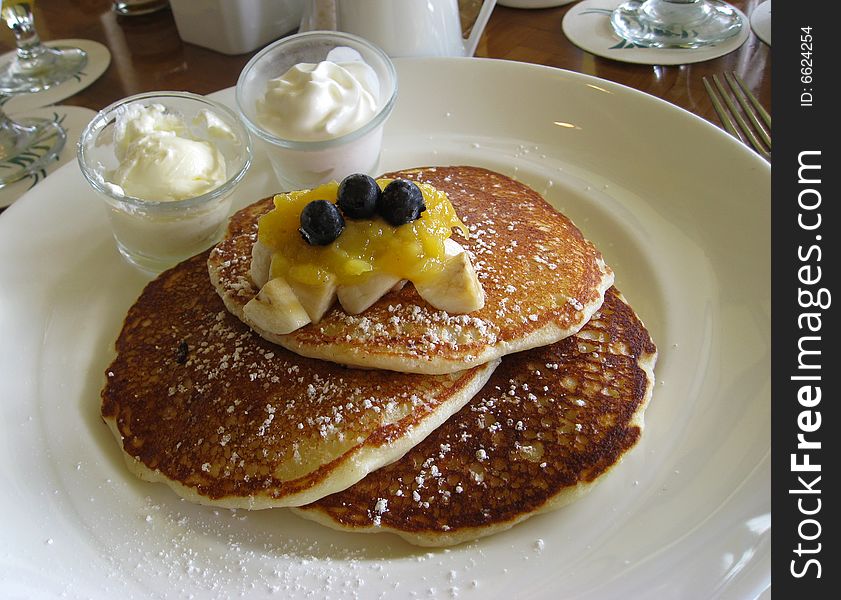 Serving of pancakes with blueberries in restaurant