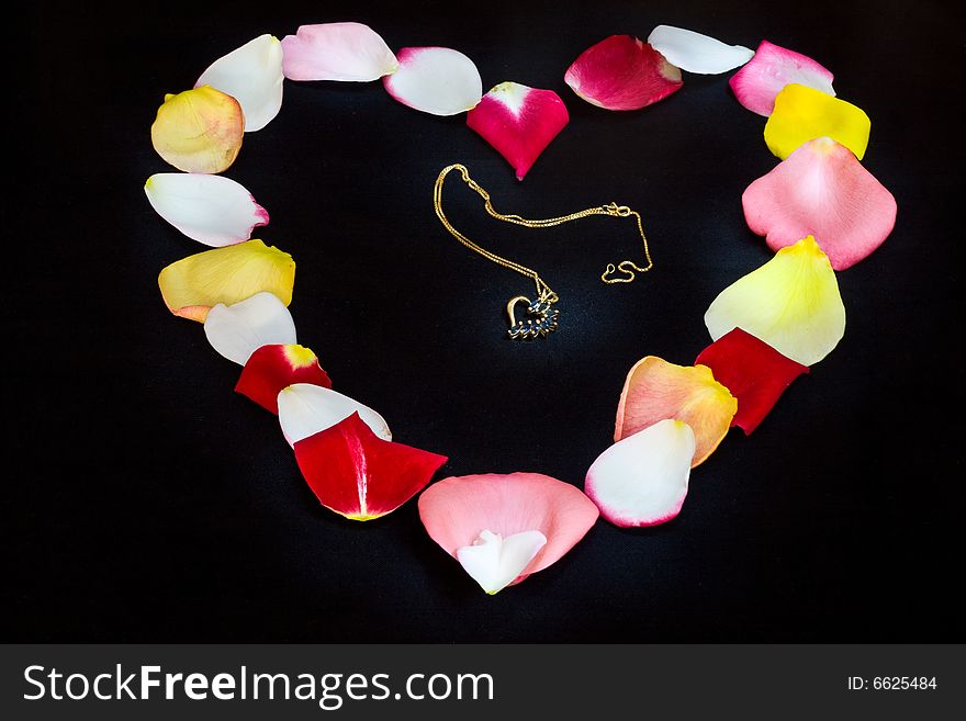 Heart-shaped pendant on rose petals