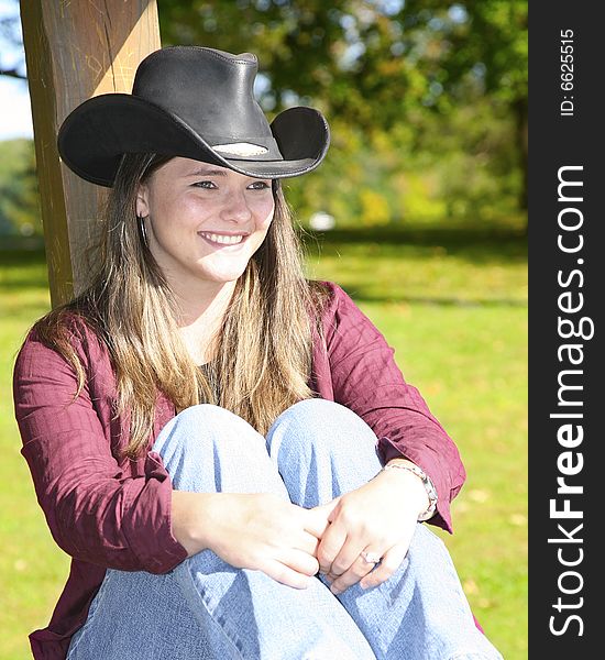 A cowgirl outside on a nice day