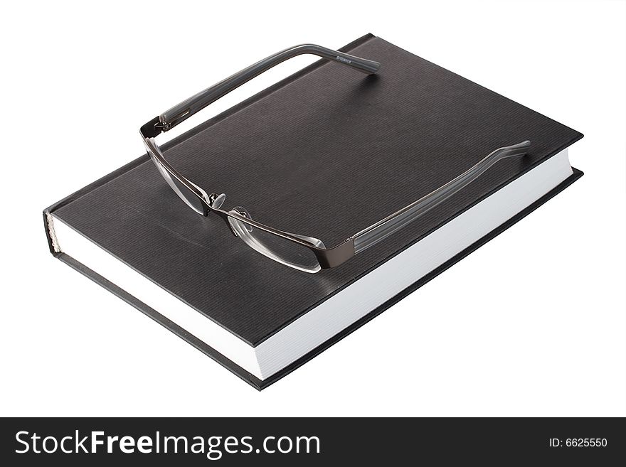 Glasses on a black book, isolated on white. Glasses on a black book, isolated on white