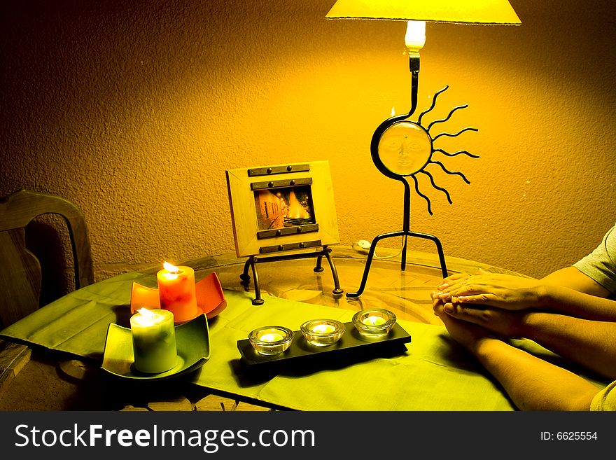 The hands of a couple entwined in an intimate corner of a home. The hands of a couple entwined in an intimate corner of a home