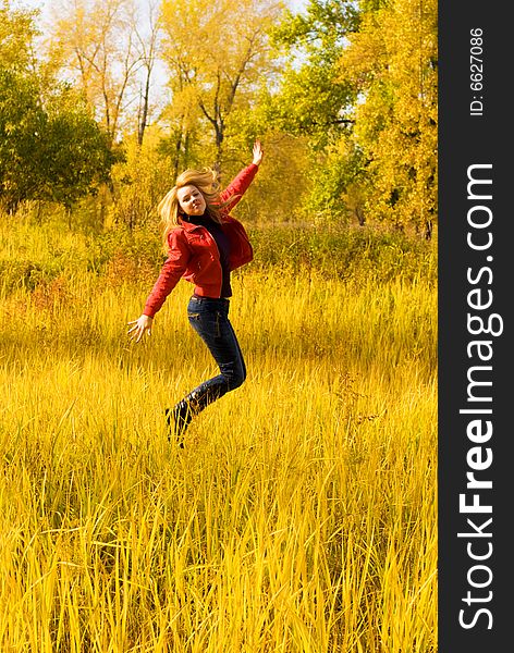 Happy Girl Jumping In The Park