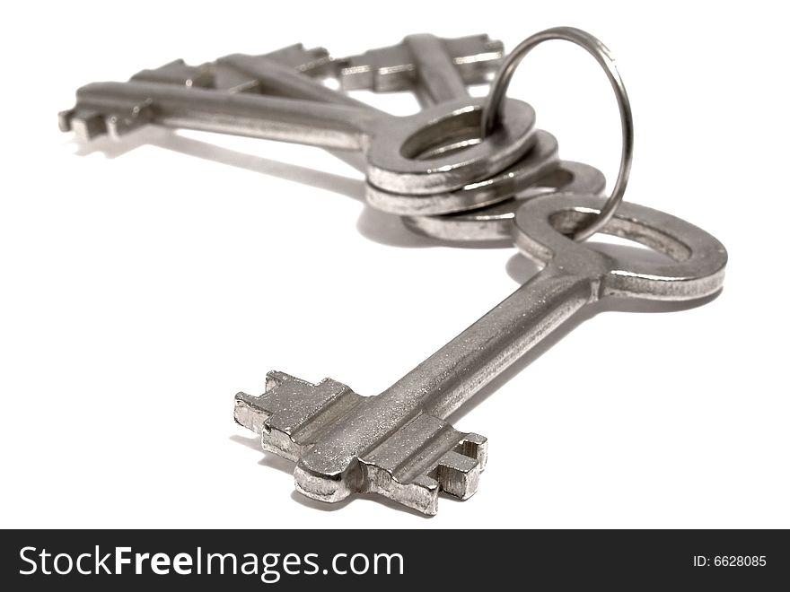 Bounch of keys from steel on a white background. Bounch of keys from steel on a white background