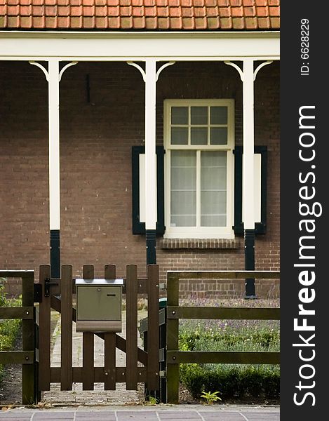 Entrance gate of a coountryside house with a wooden fence