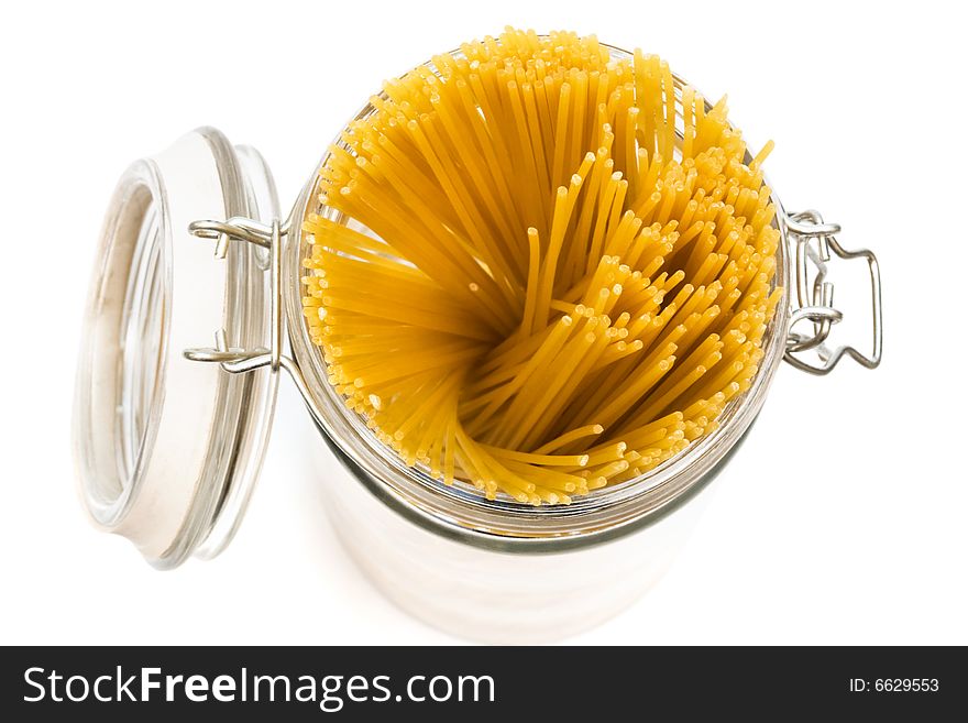 Pasta in glass can on a white background