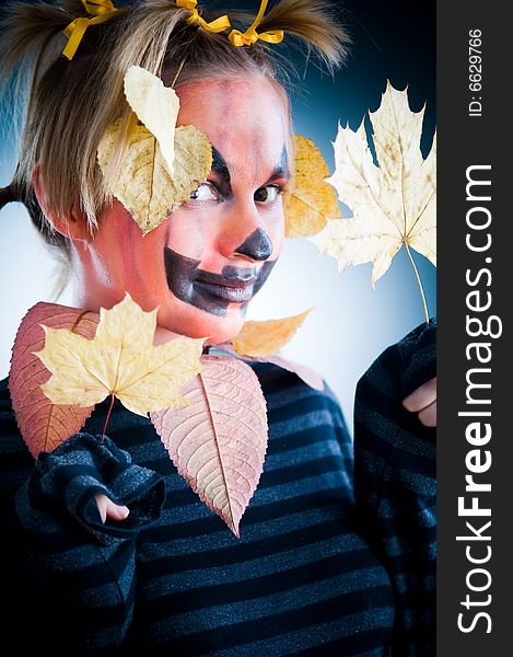 Jack-o-lantern girl with leaves isolated in studio