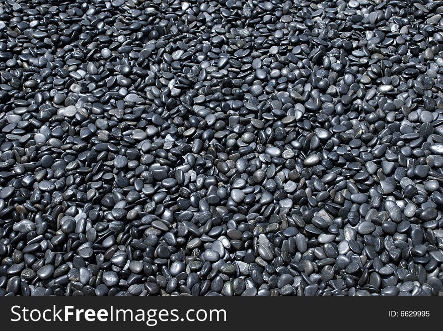 Thousands of dark grey pebbles. Thousands of dark grey pebbles