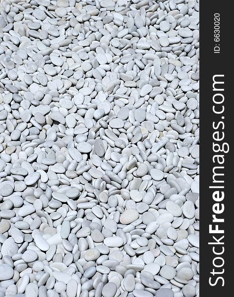 A grey stone pebble background. A grey stone pebble background