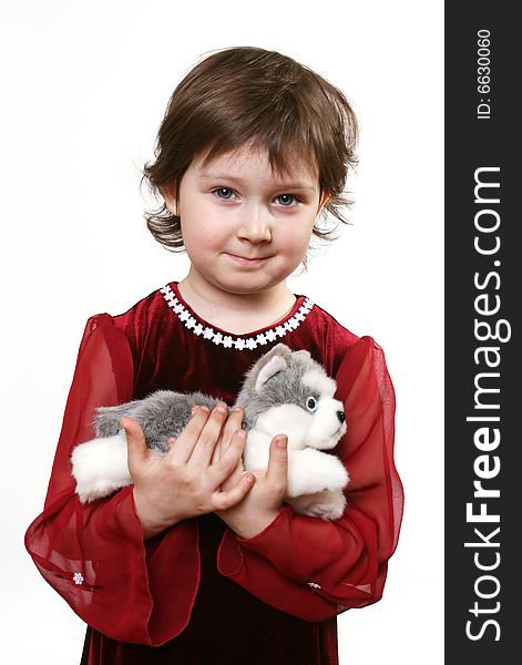 Little girl with toy puppy on white ground
