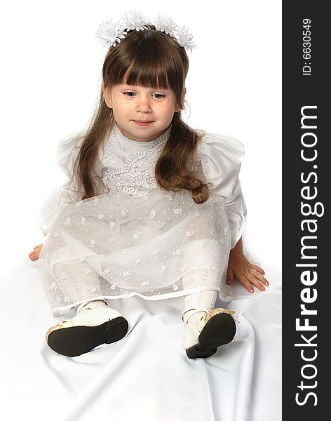 The girl in a white dress. It is isolated on a white background. Age 3 years