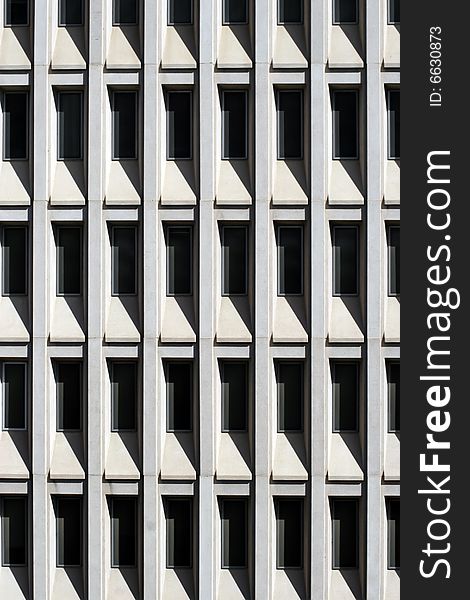 Shaded glass windows of modern office building in downtown Phoenix, Arizona. Because of the very bright and hot Arizona sunshine, modern buildings use windows recessed into the building for shade. Shaded glass windows of modern office building in downtown Phoenix, Arizona. Because of the very bright and hot Arizona sunshine, modern buildings use windows recessed into the building for shade.