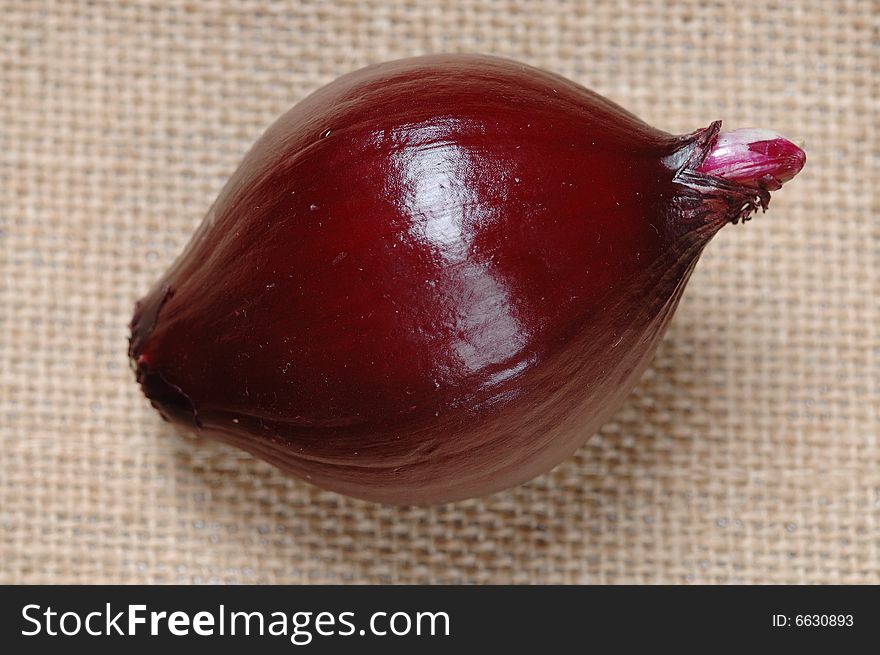 Bulb of red onion on the flax. Narrow depth of field. Bulb of red onion on the flax. Narrow depth of field.