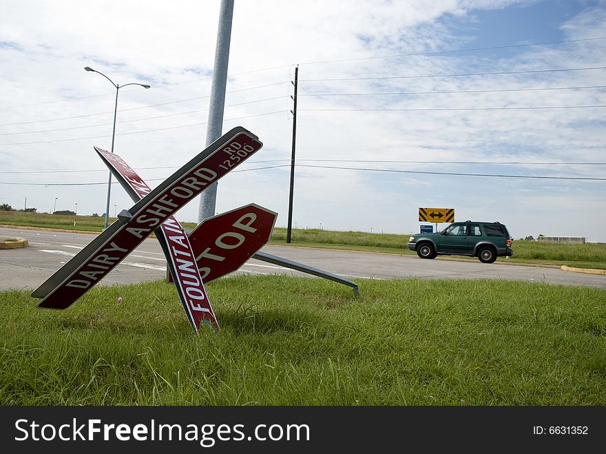 A stop sign bent and lying on the ground after a hurricane. A stop sign bent and lying on the ground after a hurricane.