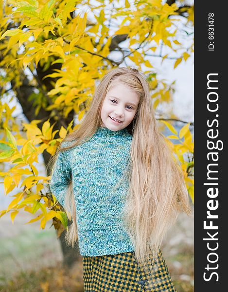 Little girl over yellow tree background. Little girl over yellow tree background