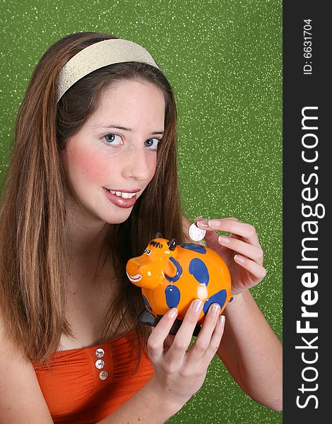 Brunette teenager on a green background wearing a broad head band. Brunette teenager on a green background wearing a broad head band