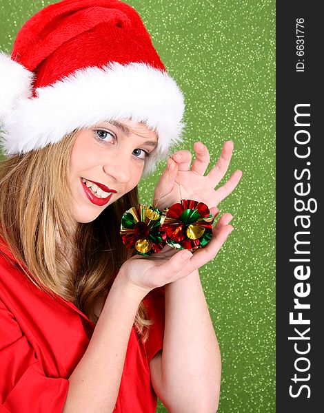 Teenager wearing a christmas hat, holding decorations. Teenager wearing a christmas hat, holding decorations
