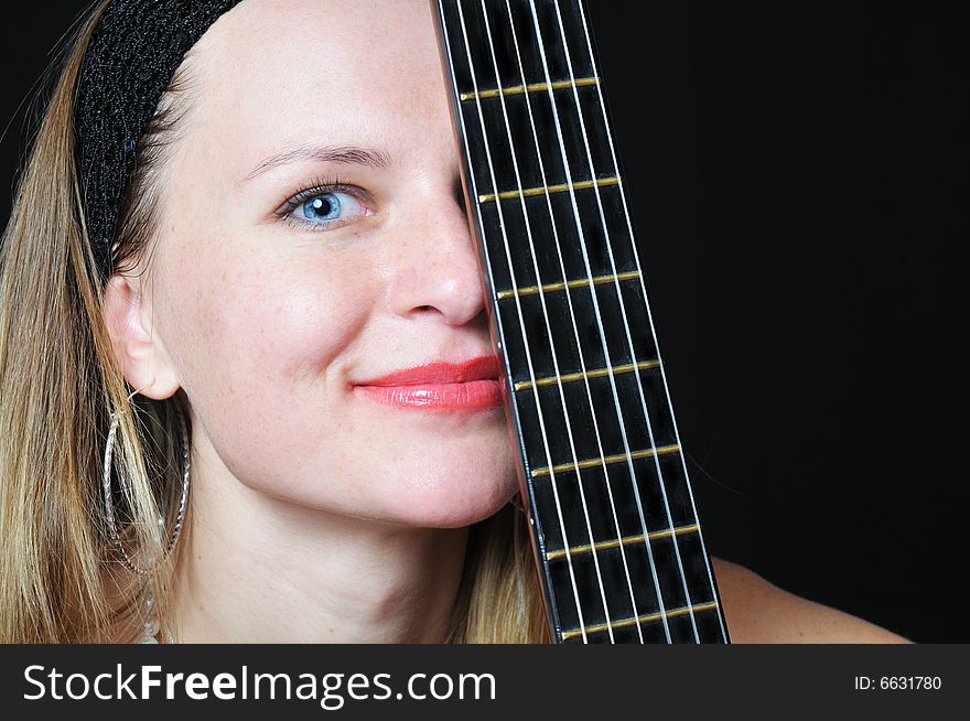 Portrait of the nice woman behind fretboard