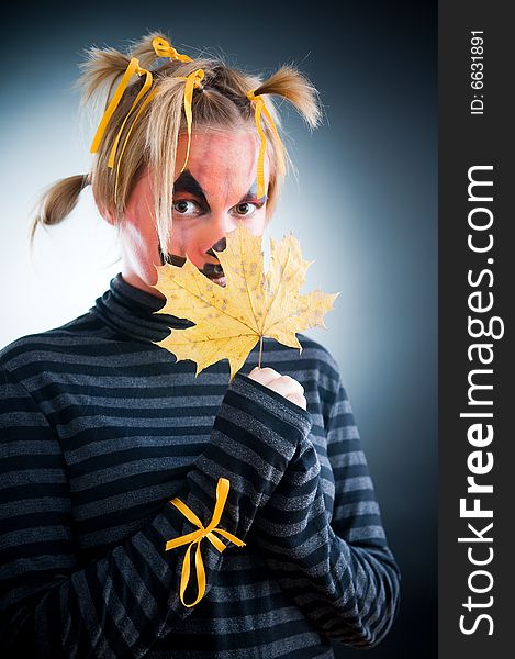 Halloween girl with leaves isolated in studio