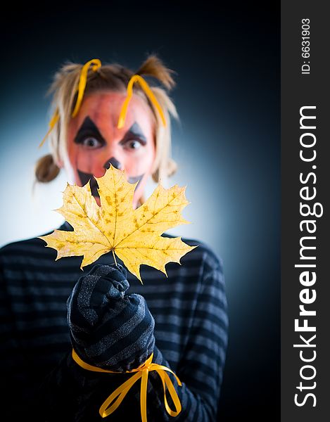 Halloween girl with tied hands, focus on leaf