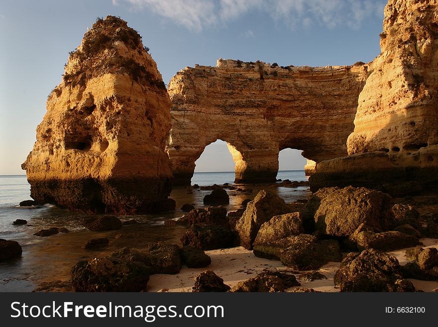 A natural formation (double arch) at the coast (Portugal) with light of sunrise. A natural formation (double arch) at the coast (Portugal) with light of sunrise.