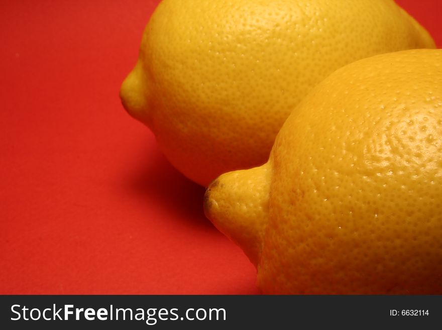 Two lemons on a red background